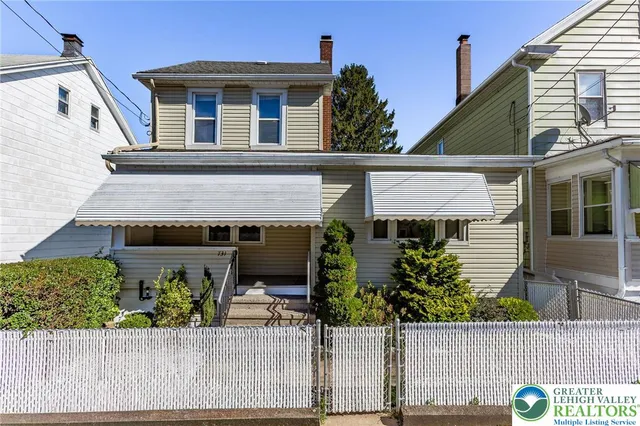 a view of a house with potted plants
