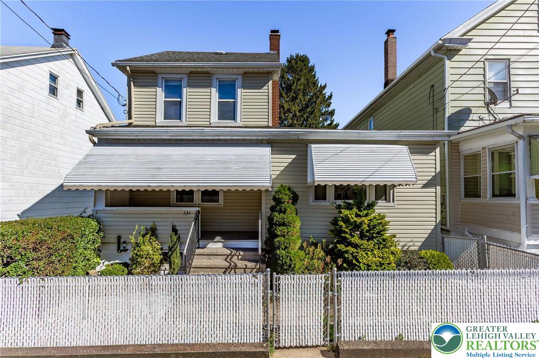 a view of a house with potted plants