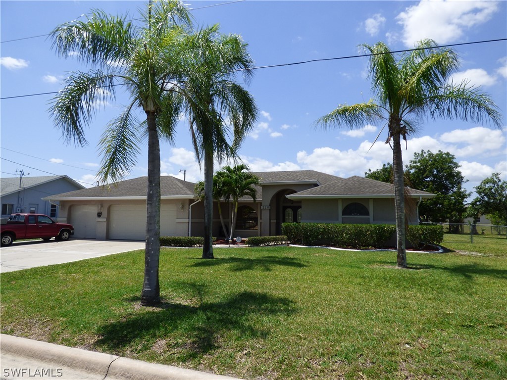 220 Danby Road Lehigh Acres, FL 33936 - Photo 4 of 35 a view of a house with a yard and palm trees