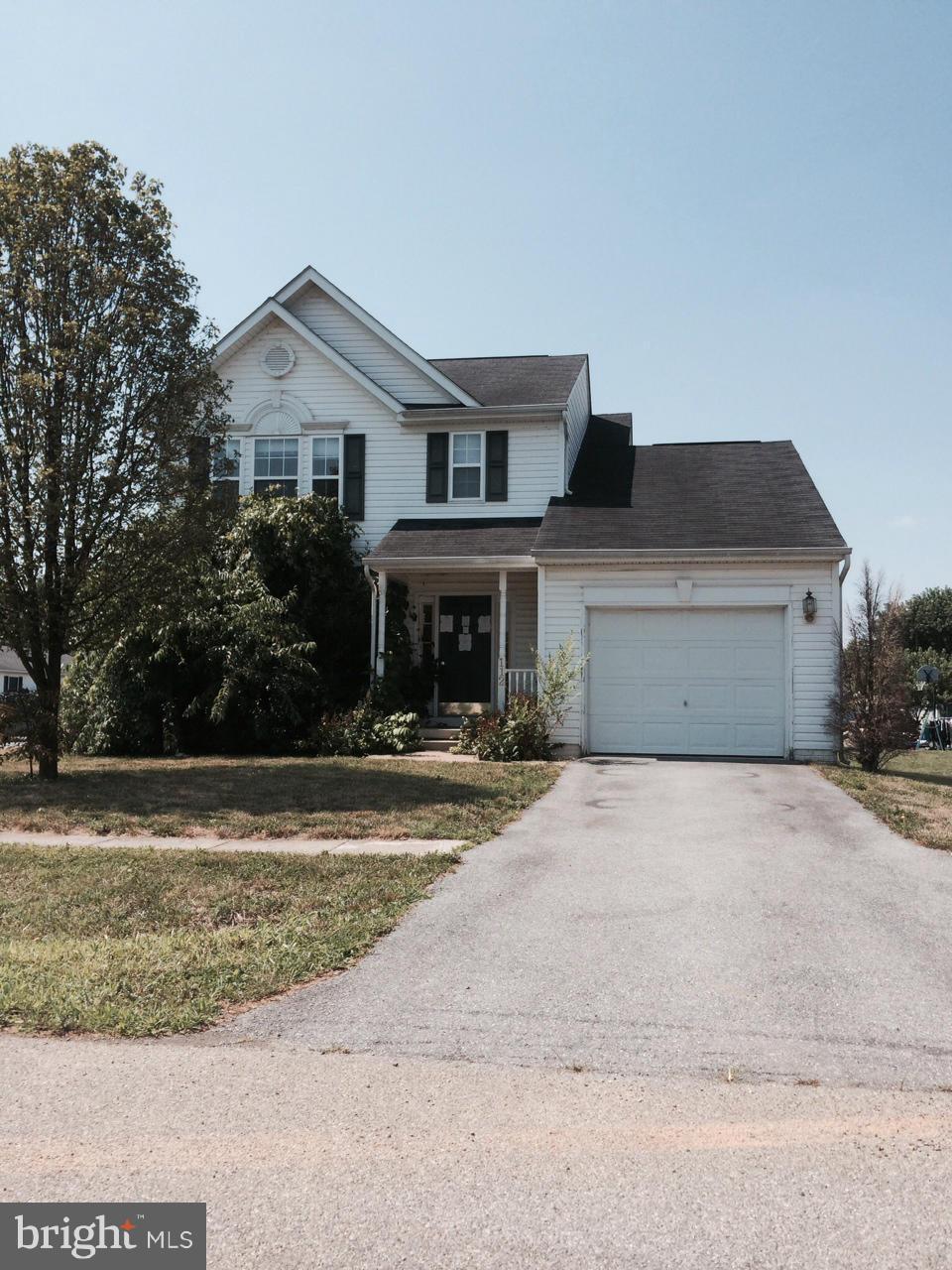 112 Estate Lane Ranson, WV 25438 - Photo 1 of 12 a front view of house with yard and trees in the background