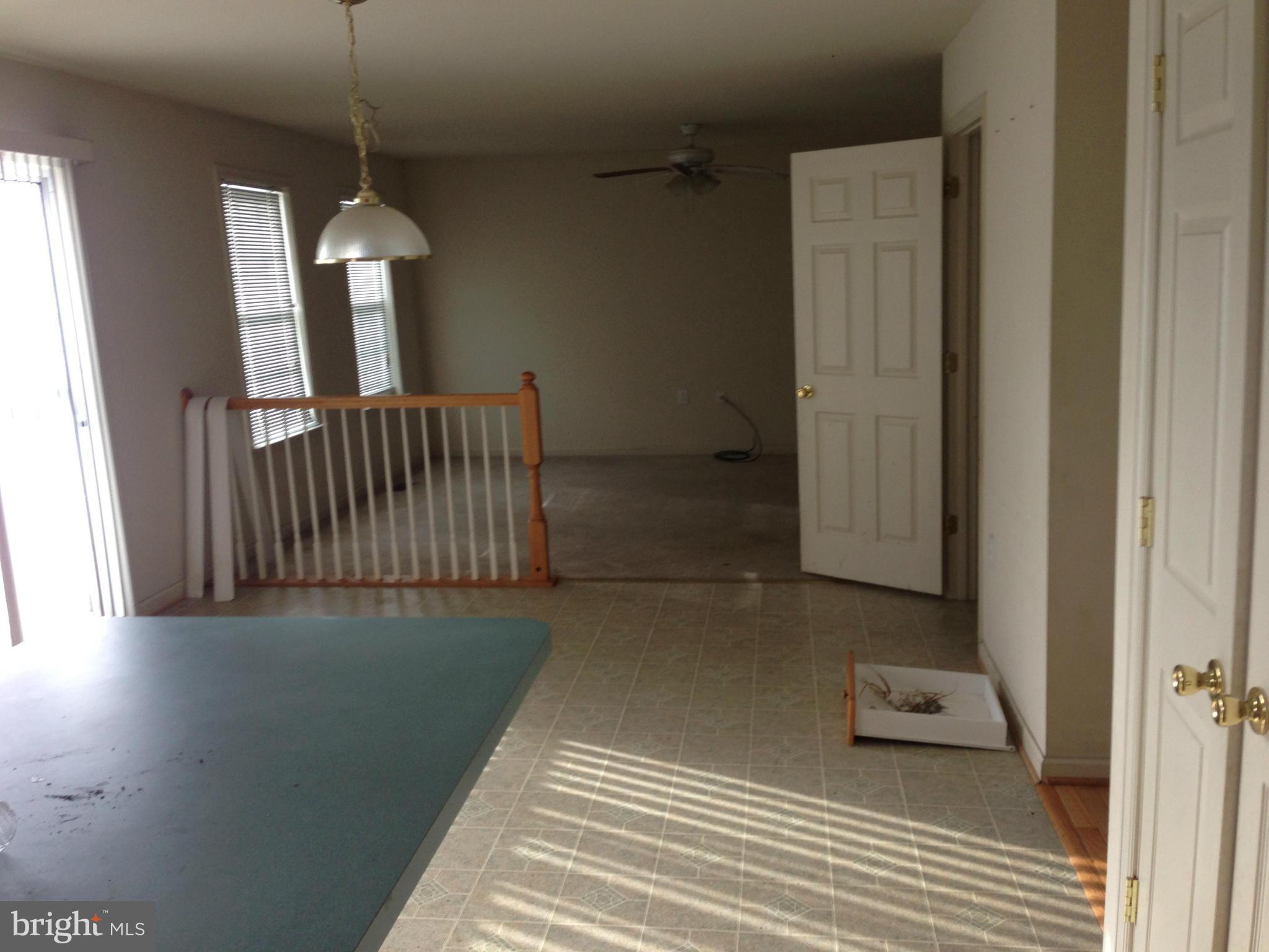 112 Estate Lane Ranson, WV 25438 - Photo 4 of 12 a view of a hallway with entryway wooden floor and front door