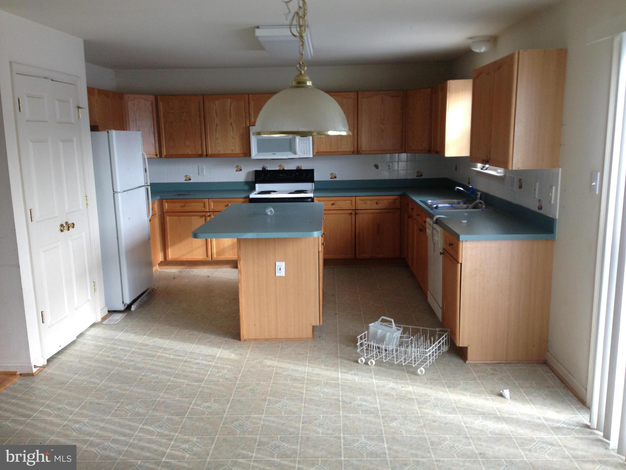 112 Estate Lane Ranson, WV 25438 - Photo 5 of 12 a kitchen with stainless steel appliances granite countertop a sink a stove and a refrigerator