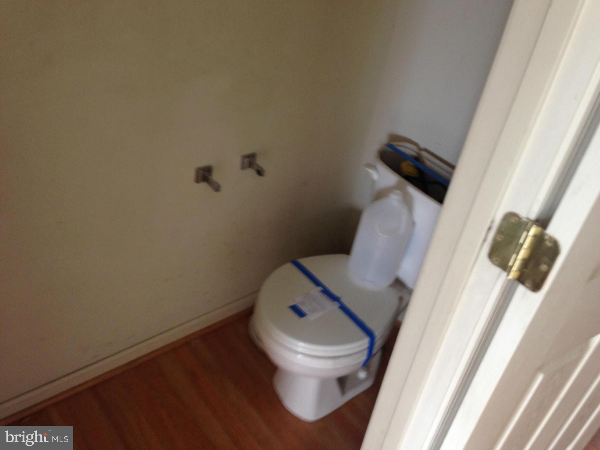 112 Estate Lane Ranson, WV 25438 - Photo 6 of 12 a white toilet sitting next to a small bathroom