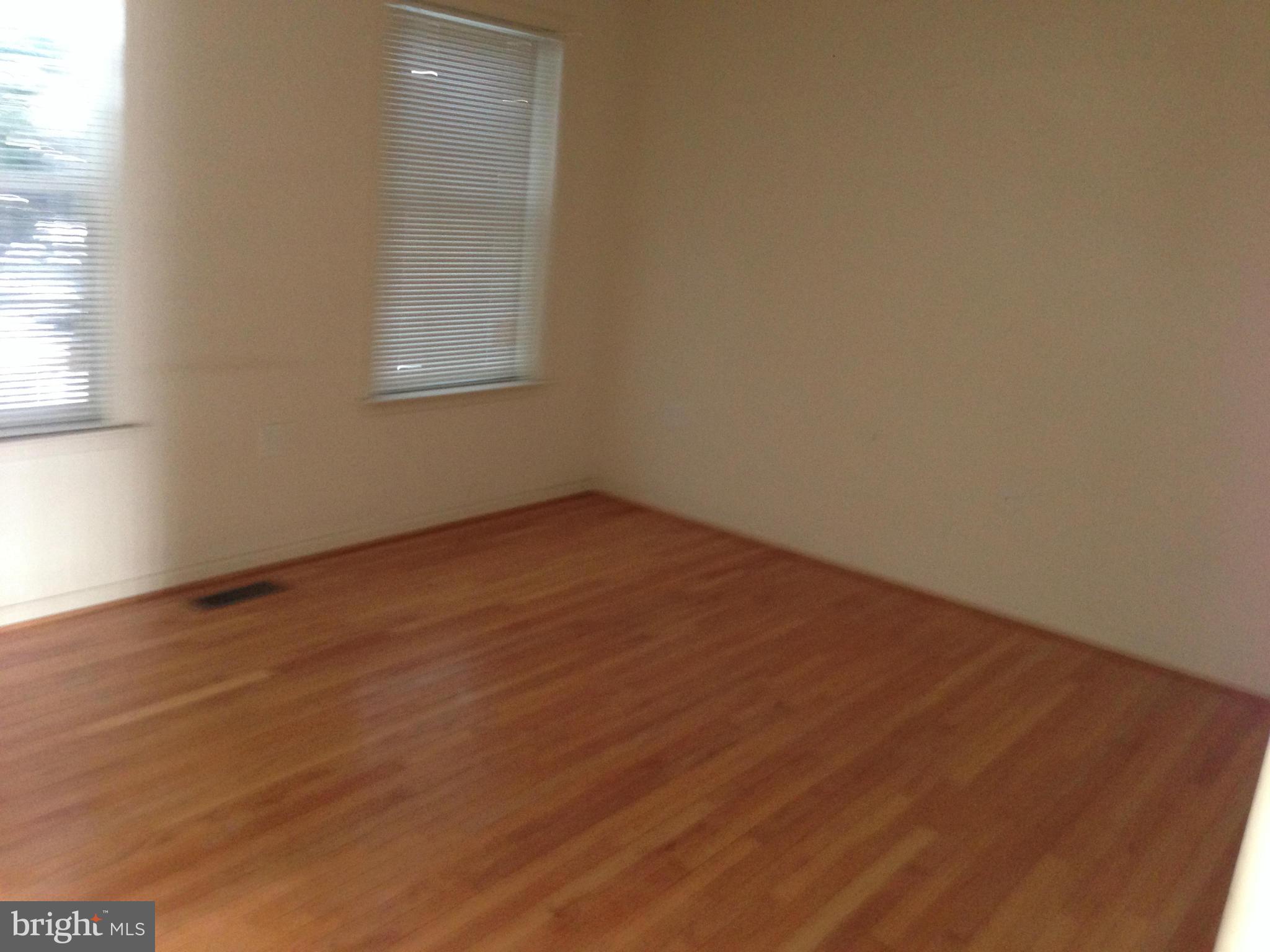 112 Estate Lane Ranson, WV 25438 - Photo 7 of 12 an empty room with wooden floor and windows