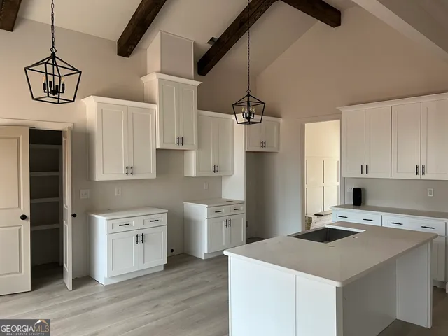 a kitchen that has a cabinets a sink and a stove