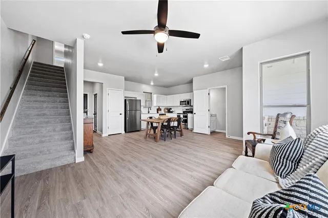 a living room with furniture and wooden floor