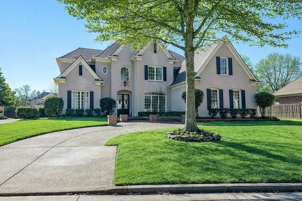 a front view of a house with a yard