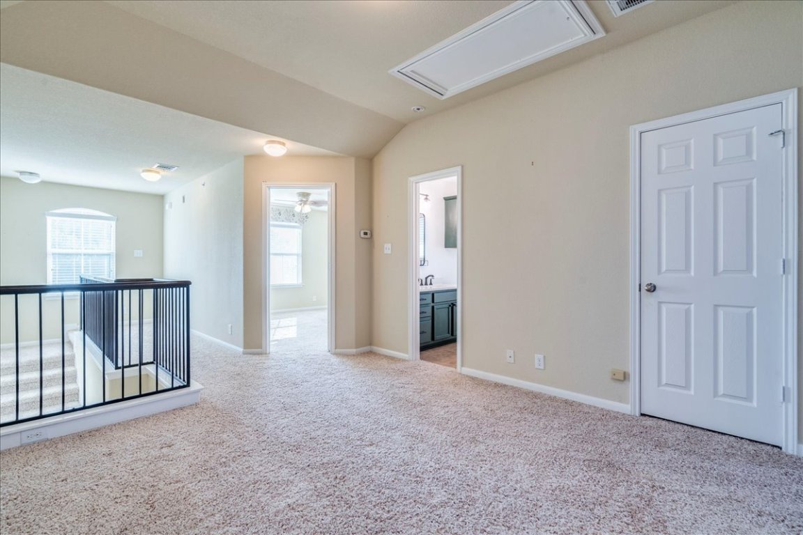 512 Lookout Tree Lane Round Rock, TX 78664 - Photo 19 of 29 Spare room with attic access, carpet, and lofted ceiling
