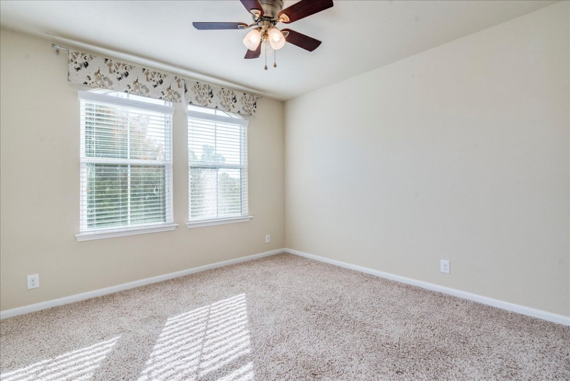 512 Lookout Tree Lane Round Rock, TX 78664 - Photo 22 of 29 Carpeted spare room featuring baseboards and a ceiling fan