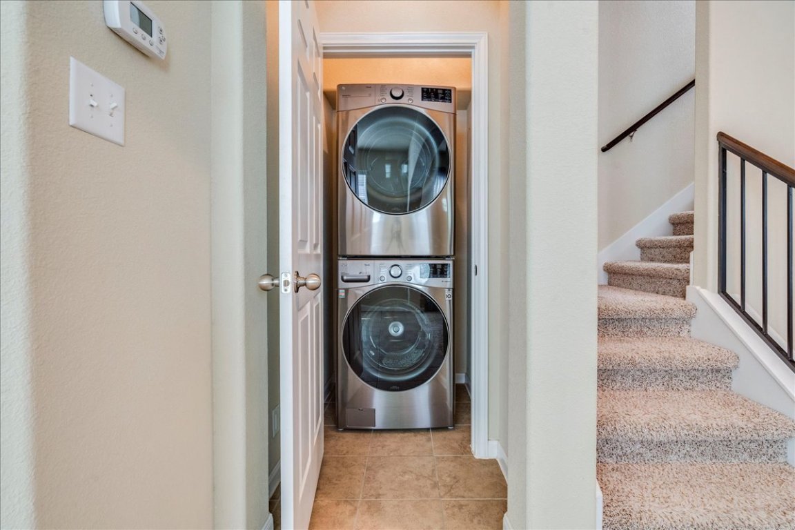 512 Lookout Tree Lane Round Rock, TX 78664 - Photo 25 of 29 Laundry room with estacked washer and dryer and light tile patterned floors