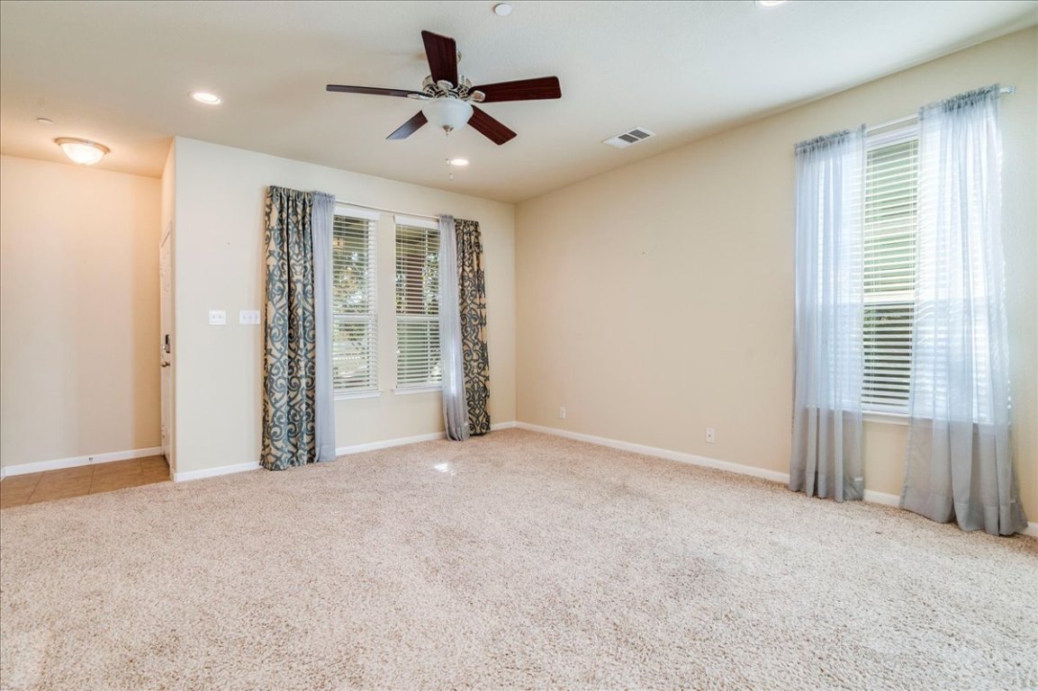 512 Lookout Tree Lane Round Rock, TX 78664 - Photo 5 of 29 Unfurnished room with plenty of natural light, light carpet, ceiling fan, and recessed lighting