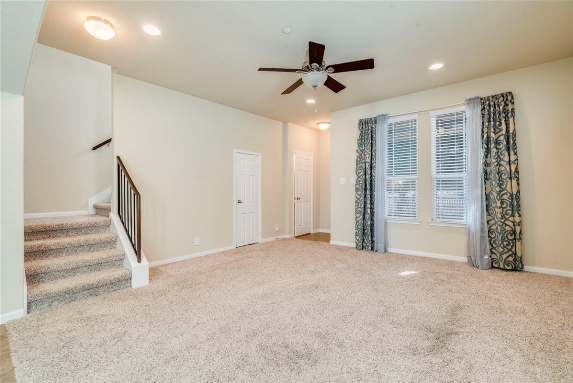512 Lookout Tree Lane Round Rock, TX 78664 - Photo 6 of 29 Unfurnished living room featuring carpet, stairway, recessed lighting, and a ceiling fan