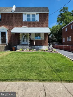 a front view of a house with a yard patio and fire pit