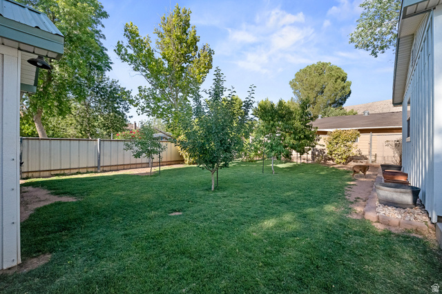 236 West 300 South Hurricane, UT 84737 - Photo 66 of 76 Expansive grassy yard featuring mature trees and a privacy fence