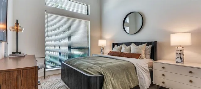 a bedroom with a bed and lamp