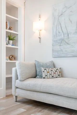 a living room with furniture and a floor to ceiling window
