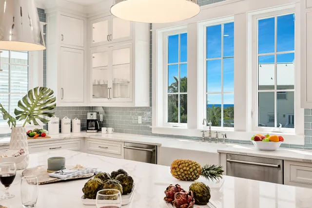 a kitchen with a sink a stove a dining table and chairs