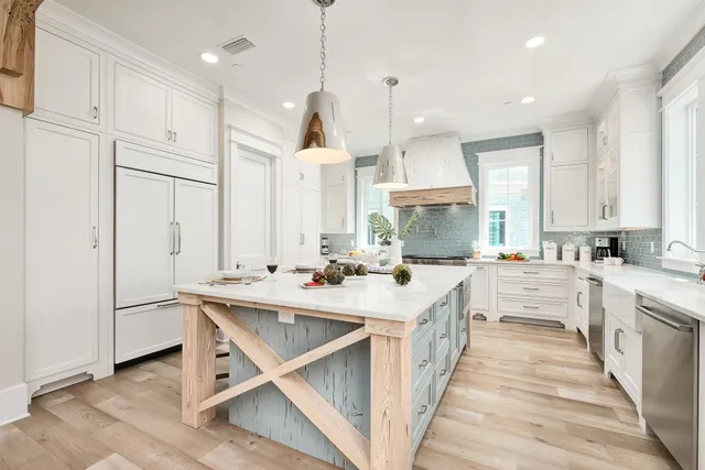 a kitchen with a counter space a sink appliances and cabinets