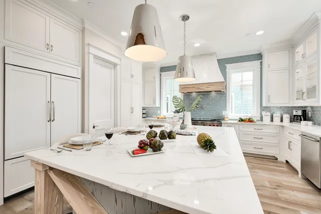 a view of a dining room and a kitchen with a sink wooden floor