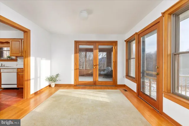 a view of a livingroom with a fireplace and a window