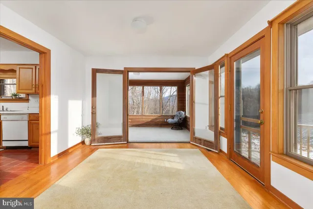 a room with pool table and windows