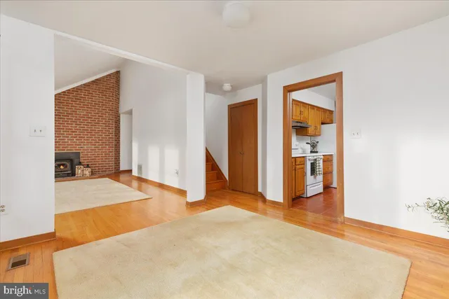 a view of a livingroom with an empty space and a fireplace