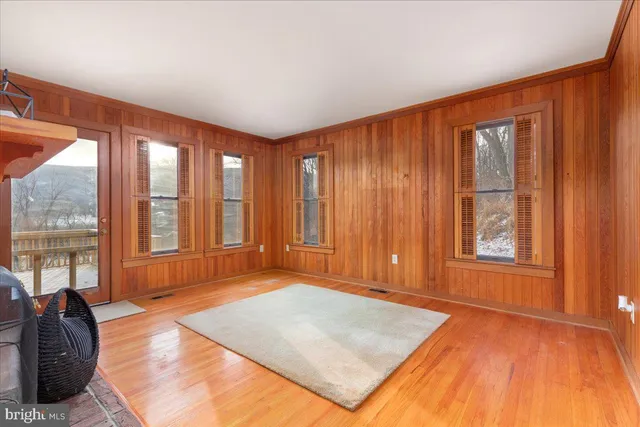 an empty room with wooden floor and closet