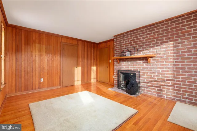 a bathroom with a toilet a sink a mirror and a window