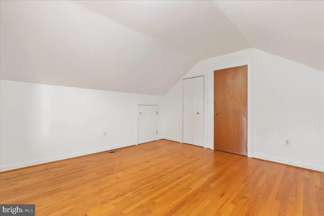 a front view of a house with a yard covered in snow
