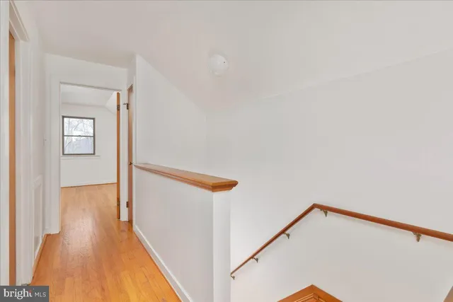 a front view of a house with a yard and covered with snow