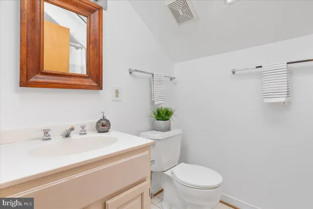 a aerial view of a house with swimming pool and large trees