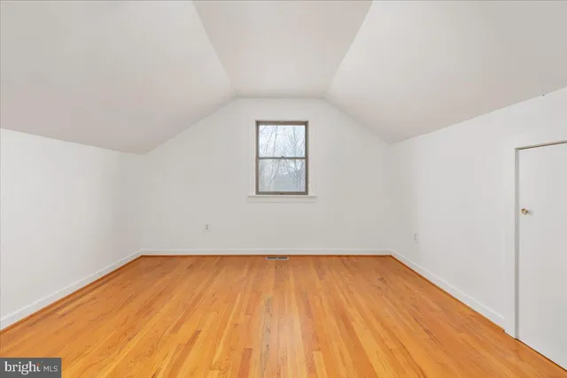 a view of a house with a yard and potted plants
