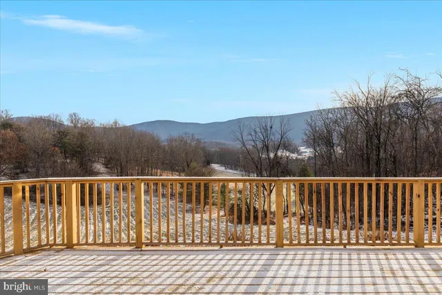 a view of a backyard with wooden fence