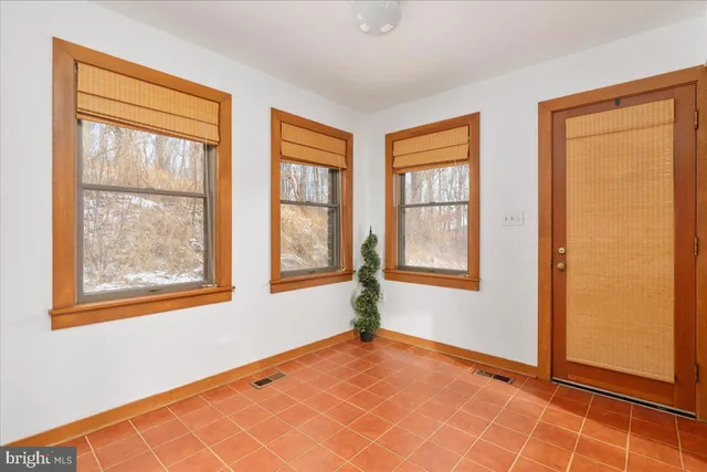 a view of an entryway with wooden floor and door