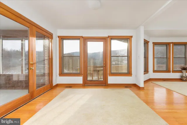 a spacious bedroom with a bed and a table in it