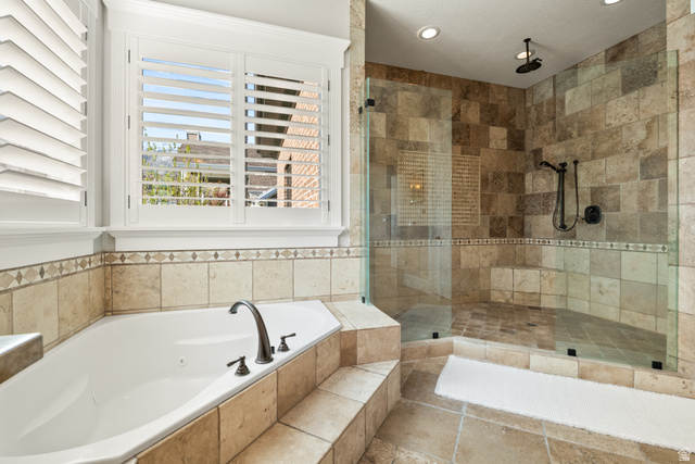 1205 North Elk Rdg Lane, Unit 202 Alpine, UT 84004 - Photo 31 of 88 Bathroom featuring a built-in corner soaking tub with deck-mounted bronze faucet and a walk-in shower with glass enclosure