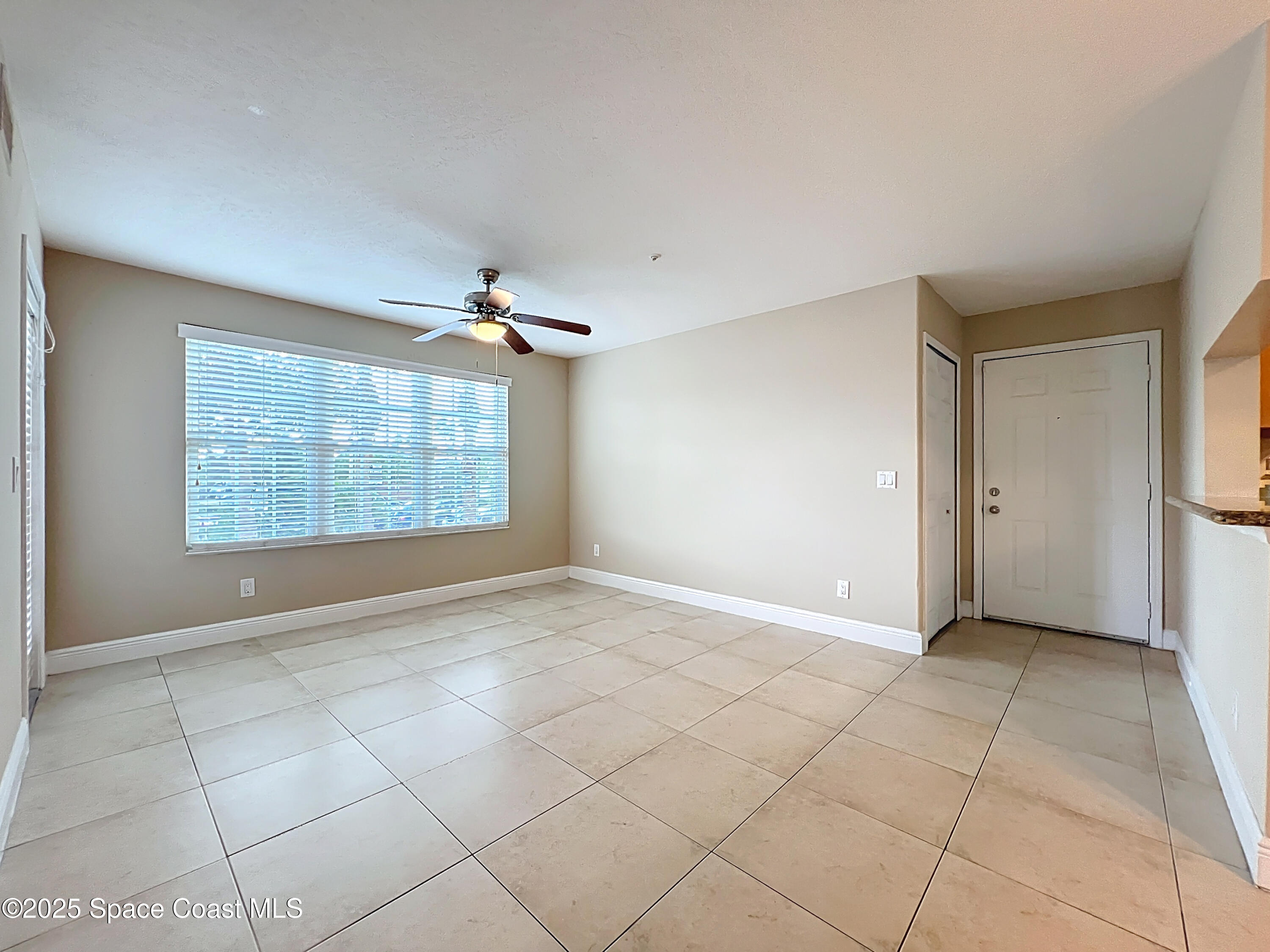 7667 North Wickham Road, Unit 410 Melbourne, FL 32940 - Photo 12 of 37 an empty room with windows and closet