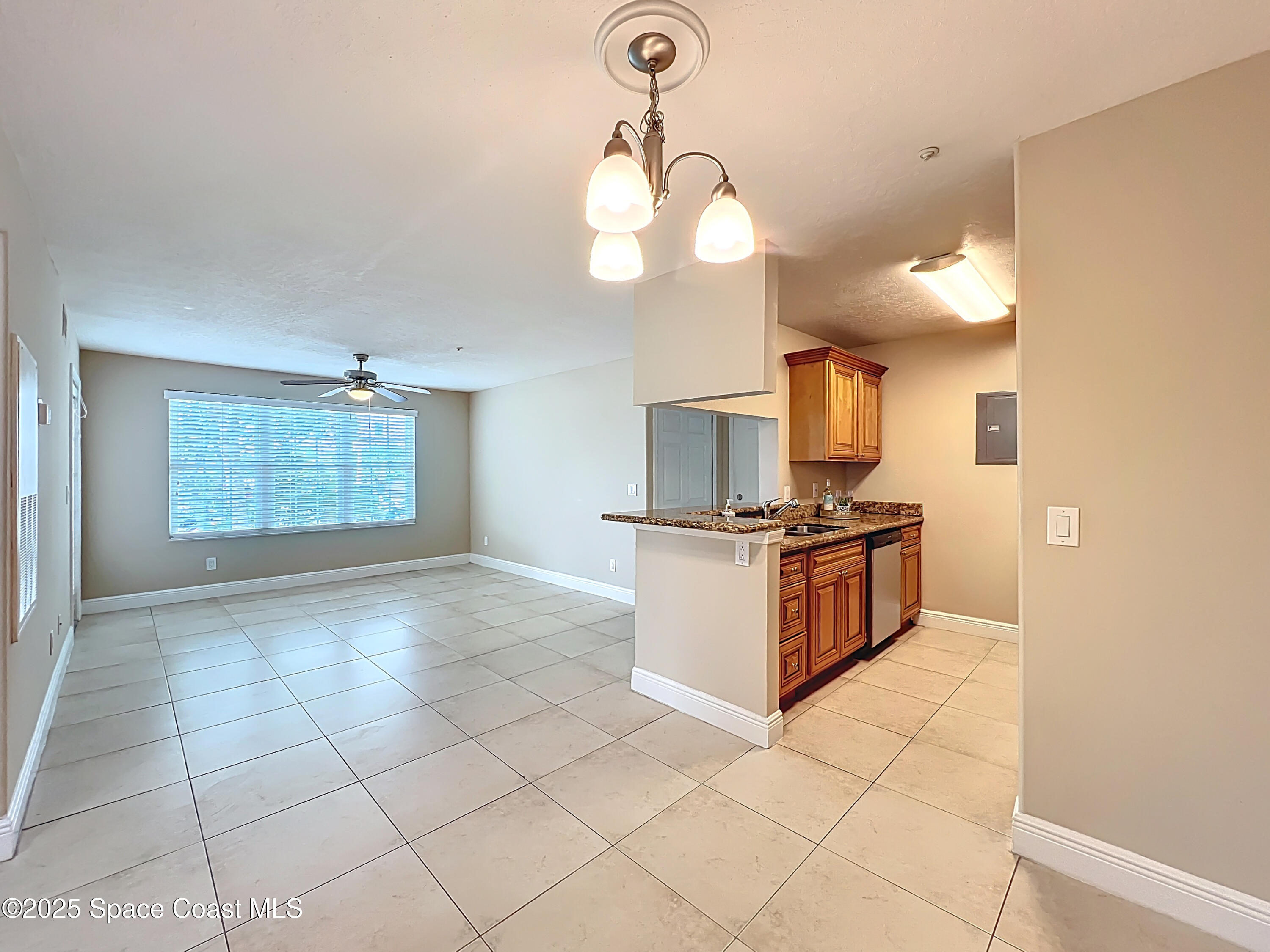 7667 North Wickham Road, Unit 410 Melbourne, FL 32940 - Photo 37 of 37 a kitchen with stainless steel appliances granite countertop a stove a sink and a refrigerator
