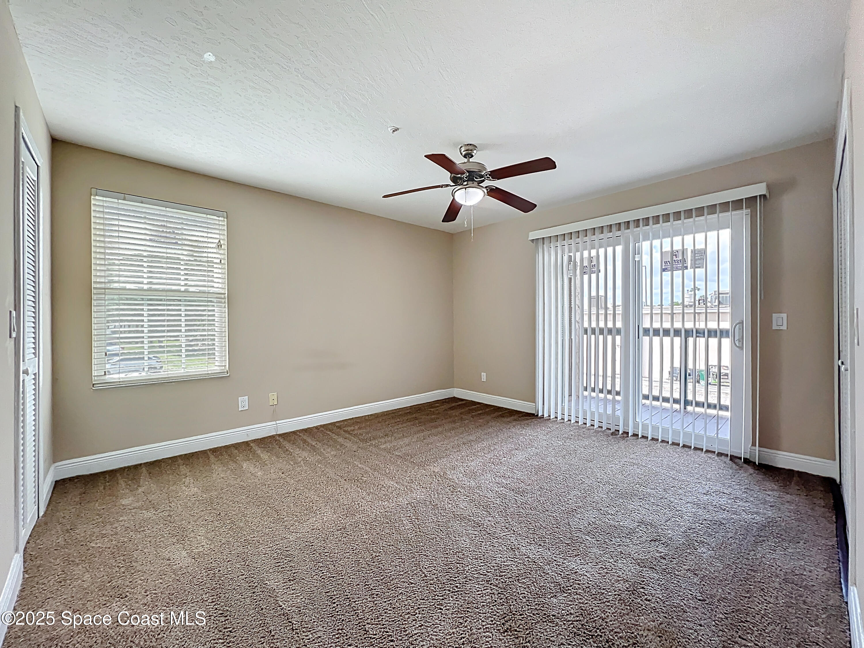 7667 North Wickham Road, Unit 410 Melbourne, FL 32940 - Photo 15 of 37 a view of an empty room with a window