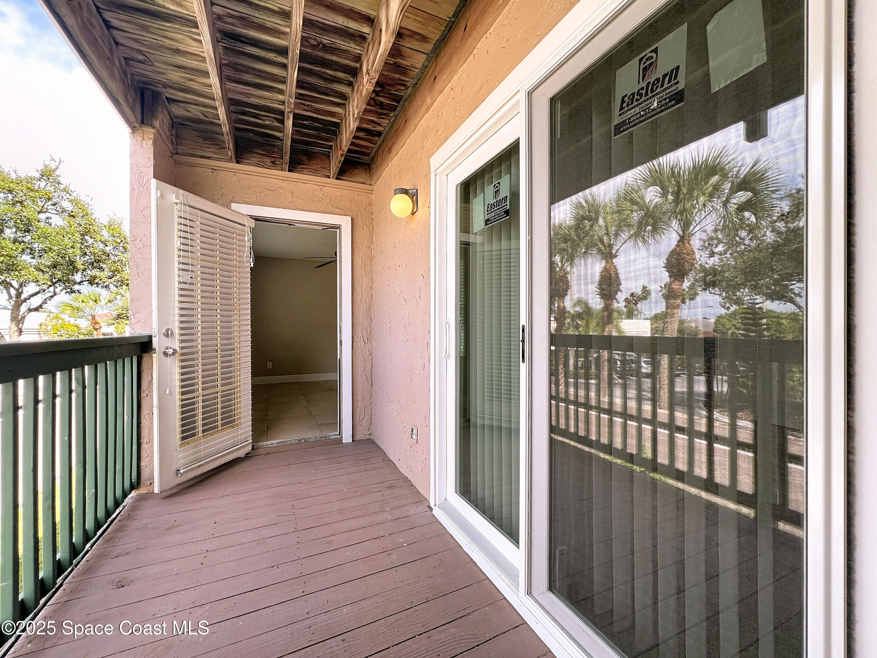 7667 North Wickham Road, Unit 410 Melbourne, FL 32940 - Photo 22 of 37 a view of wooden balcony