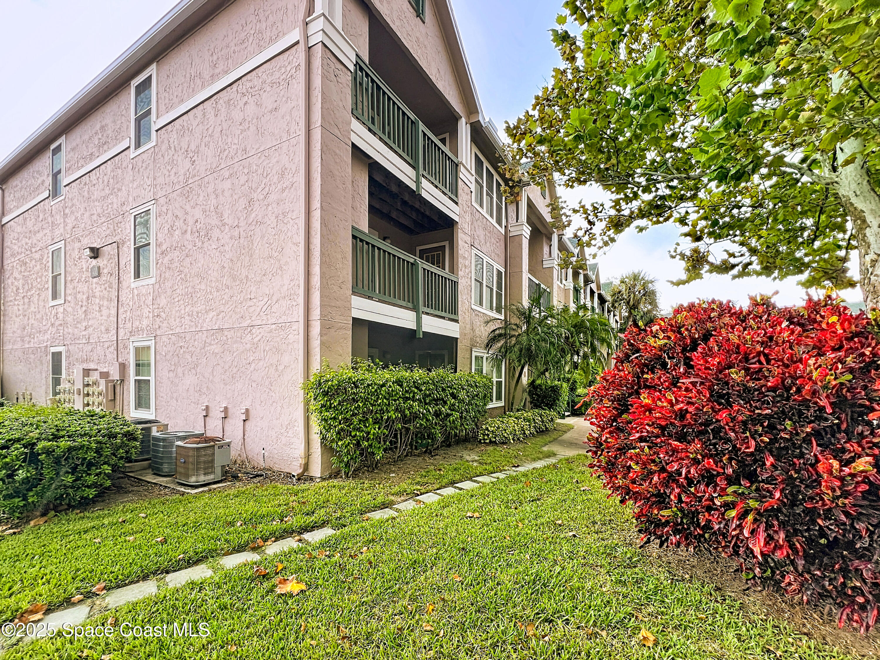 7667 North Wickham Road, Unit 410 Melbourne, FL 32940 - Photo 23 of 37 a view of a pathway with a house in front of it