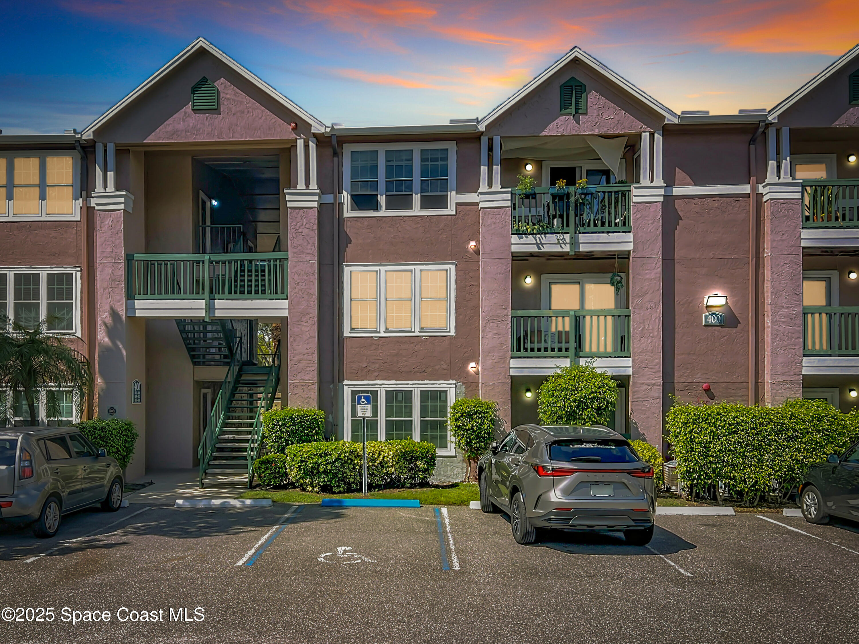 7667 North Wickham Road, Unit 410 Melbourne, FL 32940 - Photo 24 of 37 front view of a brick house with a yard