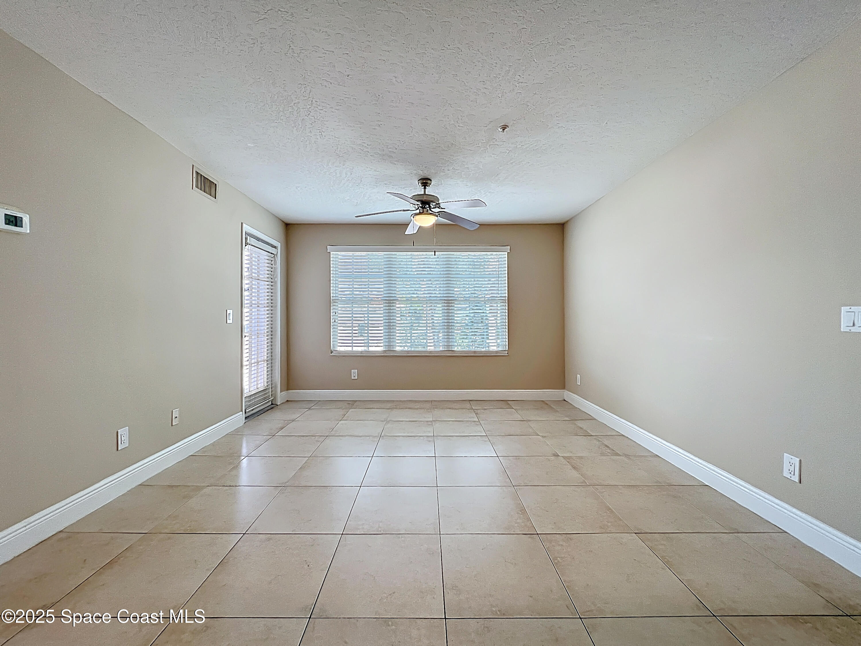 7667 North Wickham Road, Unit 410 Melbourne, FL 32940 - Photo 4 of 37 a view of an empty room with a window