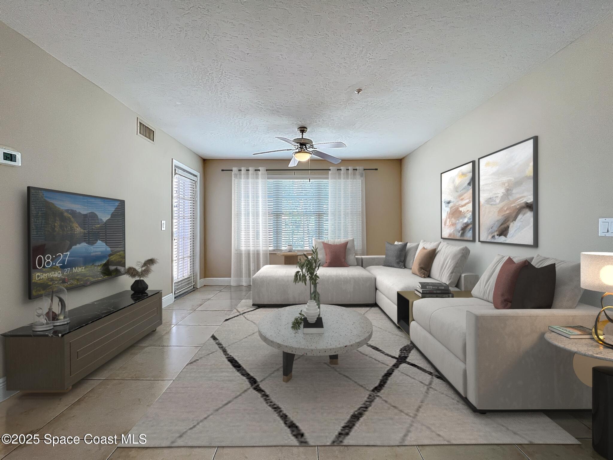 7667 North Wickham Road, Unit 410 Melbourne, FL 32940 - Photo 5 of 37 a living room with furniture and a flat screen tv