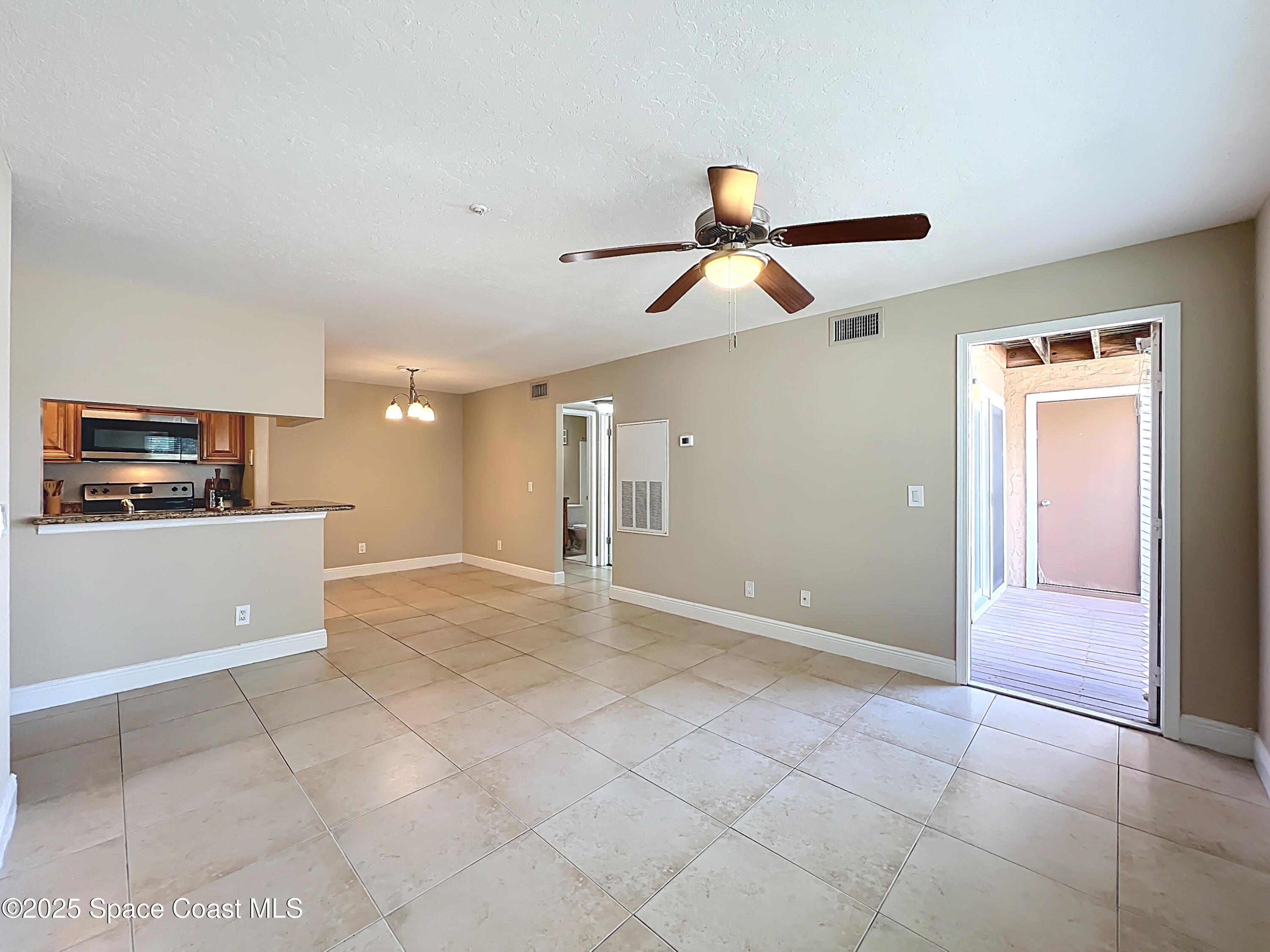 7667 North Wickham Road, Unit 410 Melbourne, FL 32940 - Photo 6 of 37 a view of room with ceiling fan and window