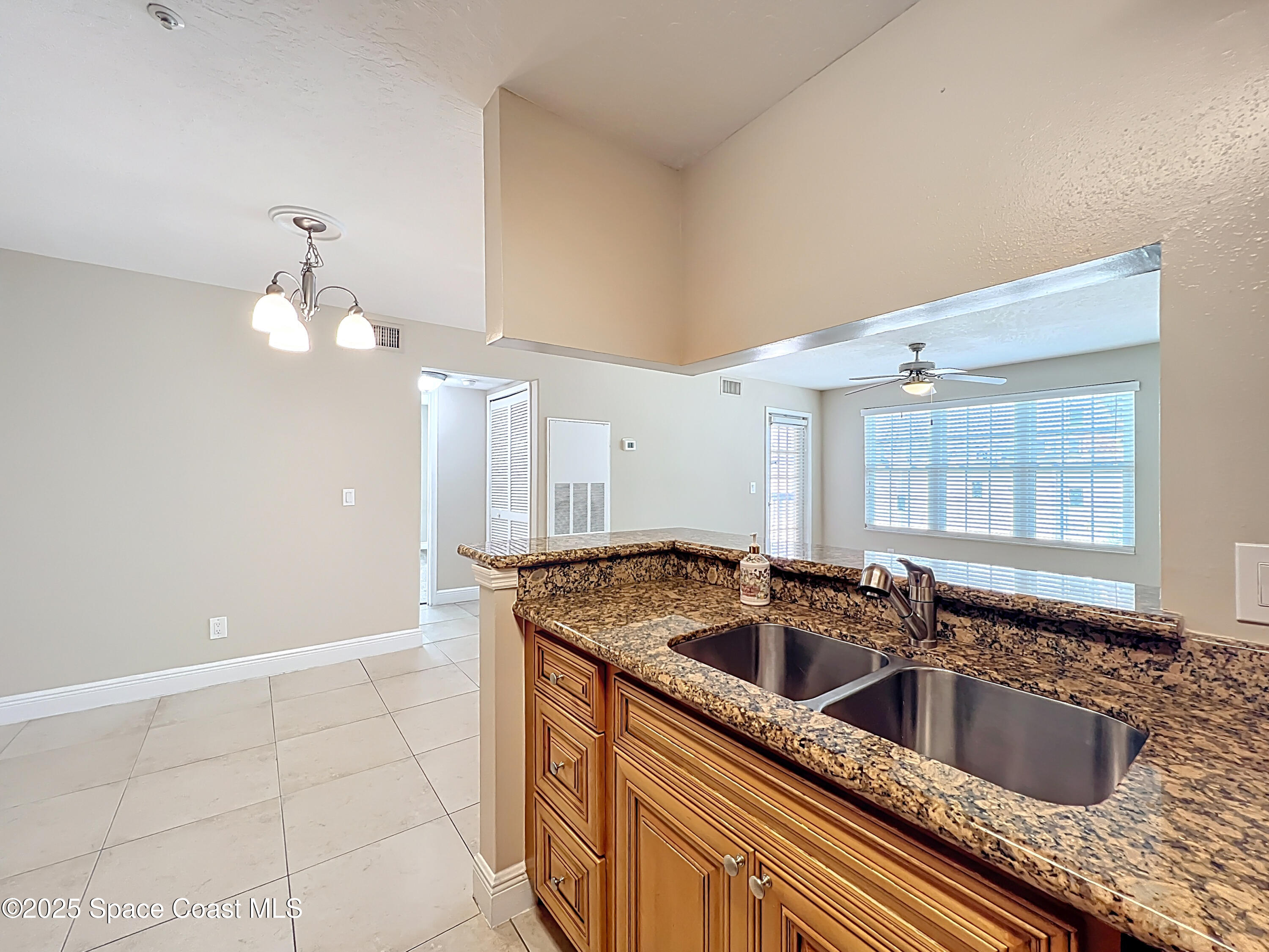 7667 North Wickham Road, Unit 410 Melbourne, FL 32940 - Photo 10 of 37 a kitchen with a sink and cabinets