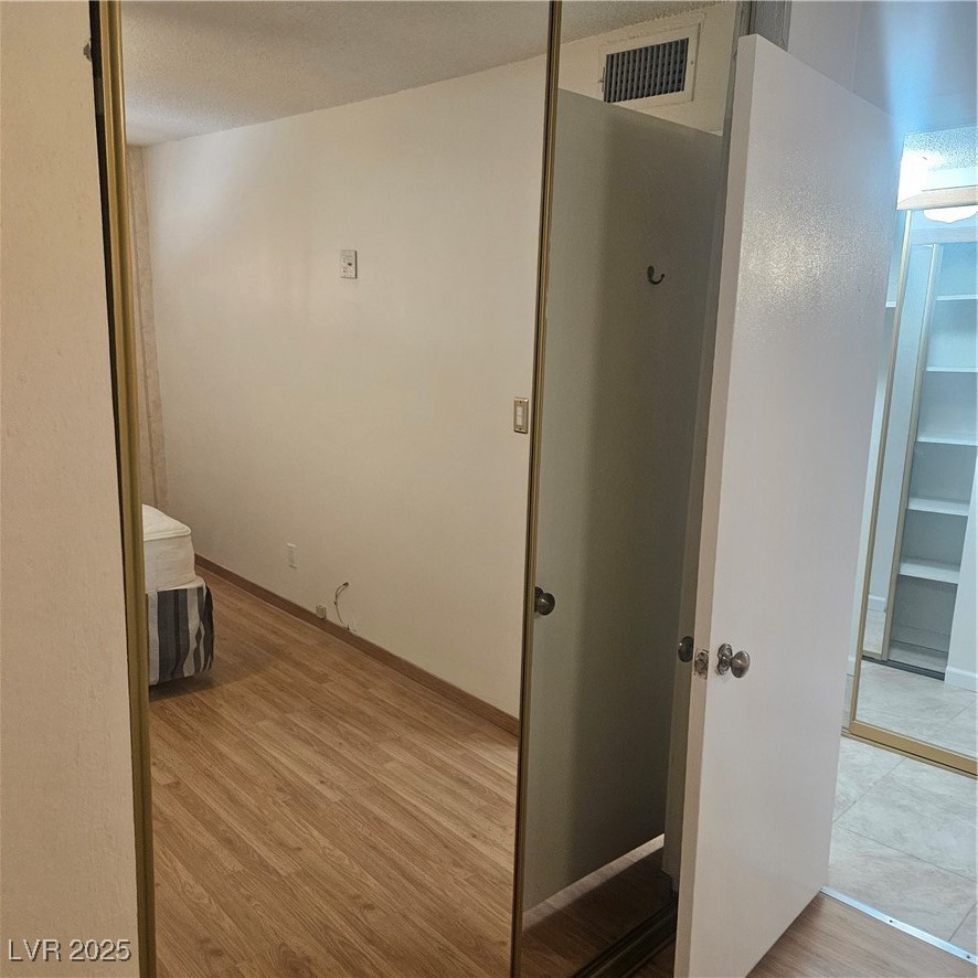 350 East Desert Inn Road, Unit C203 Las Vegas, NV 89109 - Photo 20 of 35 Hall with light wood-style flooring and a textured ceiling