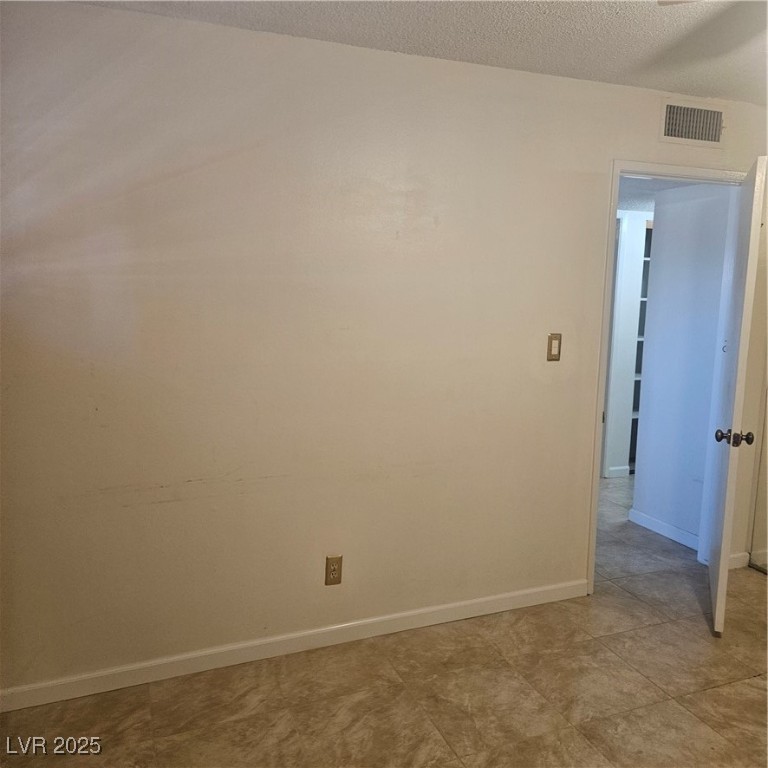 350 East Desert Inn Road, Unit C203 Las Vegas, NV 89109 - Photo 23 of 35 Empty room with baseboards and a textured ceiling