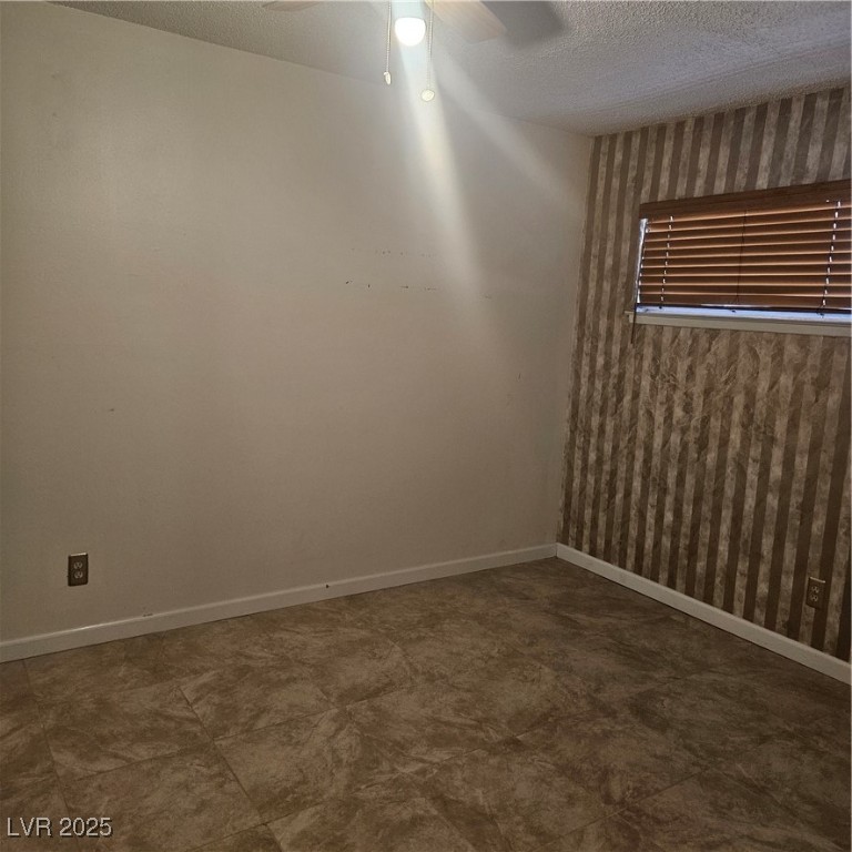 350 East Desert Inn Road, Unit C203 Las Vegas, NV 89109 - Photo 26 of 35 Unfurnished room featuring a textured ceiling and ceiling fan
