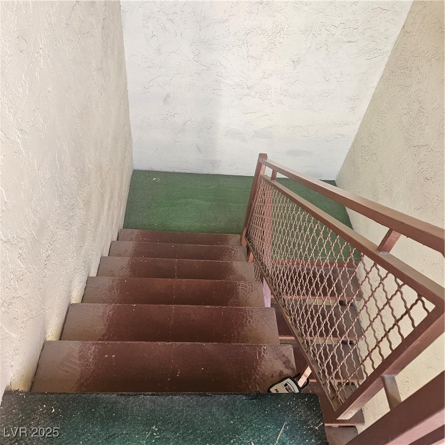 350 East Desert Inn Road, Unit C203 Las Vegas, NV 89109 - Photo 27 of 35 Staircase with a textured wall